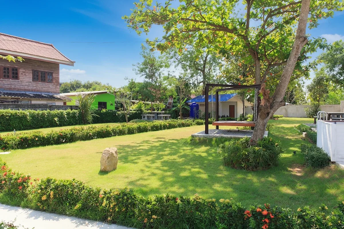 The Maple Pattaya outdoor swimming pool with blue tiles and a modern building in the background.