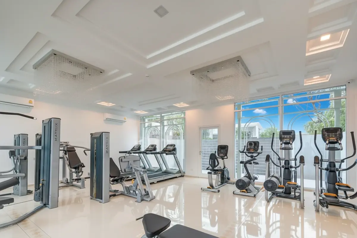 The Orient Resort & Spa elegant reception desk in the lobby with a large floral arrangement and seating area.