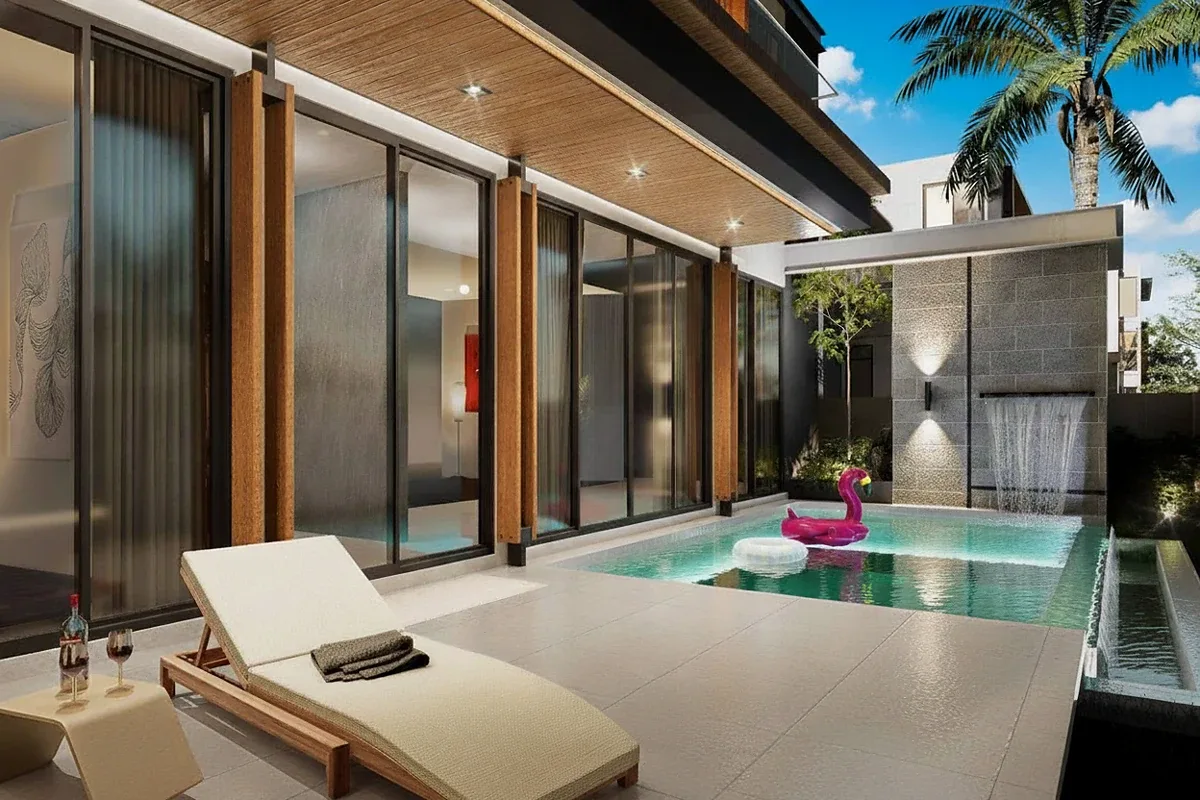 The Ozone Wealth Jomtien Pool Villa Pattaya: Private pool with waterfall feature, lounge chair, and glass sliding doors.