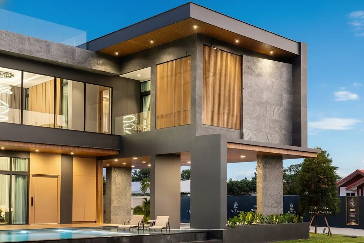 The Sylva Pattaya modern house corner with large windows, wooden accents, and a swimming pool.