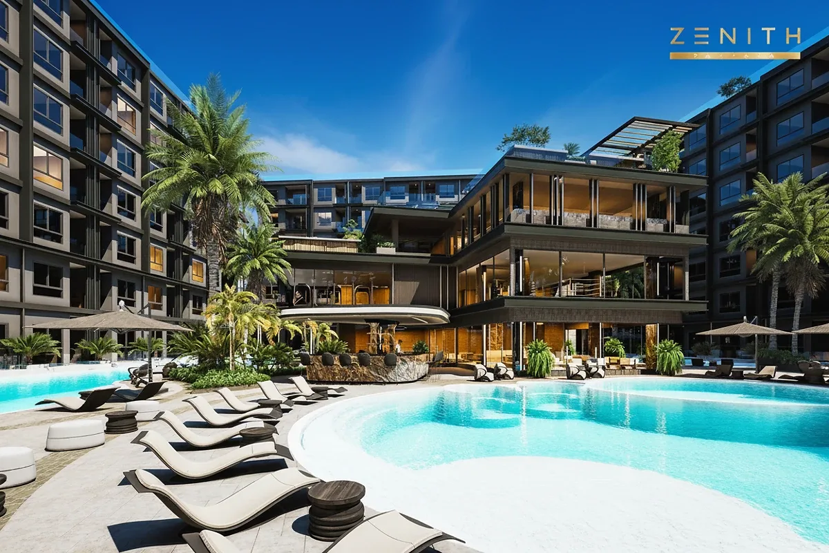 Zenith Pattaya large outdoor swimming pool with sun loungers, surrounded by modern buildings and palm trees.