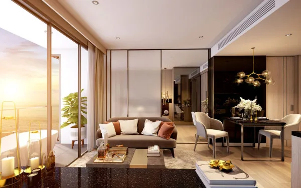 The Panora Pattaya bedroom with a balcony bathtub and ocean view, featuring a sofa and large bed.