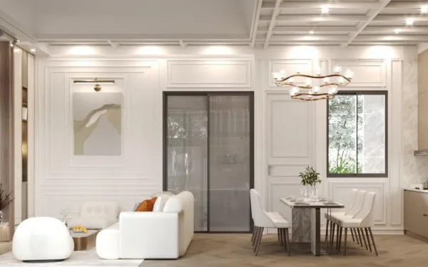 Larelana Villa living area with white sofa, modern chandelier, and dining table next to a glass sliding door.