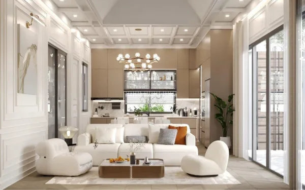 Larelana Villa spacious living room with white sofas, coffee table, and view into the modern kitchen area.