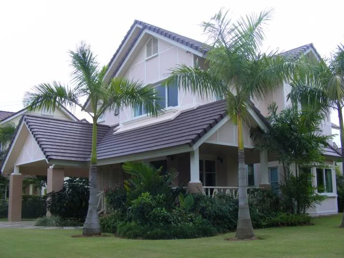 Central Park Hillside house exterior with a blue tiled swimming pool and dolphin statue.