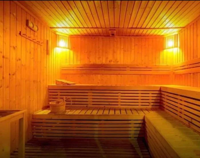 Centara Avenue Residence and Suites restaurant interior with a large cylindrical aquarium and stylish pendant lights.