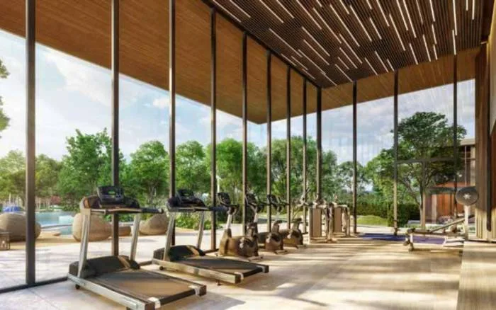 Highland Park Pool Villas Pattaya grand entrance gate with modern architectural design, lush landscaping, and a prominent sign.