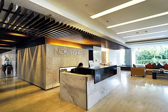 Northshore Pattaya modern fitness center with various weight training machines, benches, and mirrors.