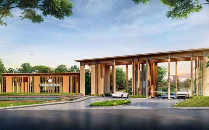 Highland Park Pool Villas Pattaya modern clubhouse building with large glass windows, wooden pillars, and a tranquil water feature.