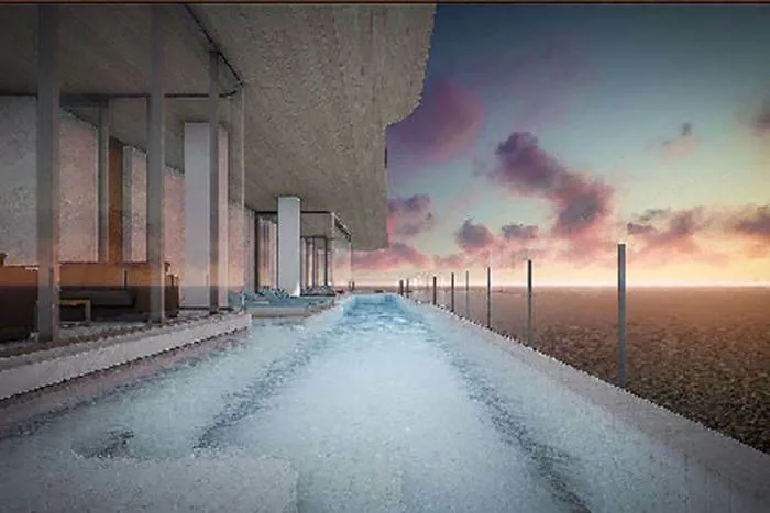 Arom Jomtien long, narrow infinity pool on a high floor overlooking the ocean at sunset.