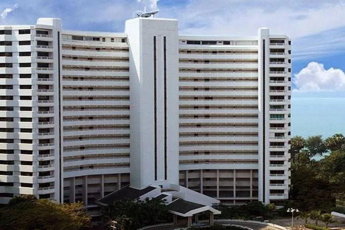 Grand Condotel exterior showing the tall white building from a low angle with a curved entrance.