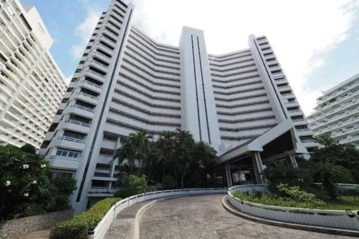 Grand Condotel main building exterior with curved driveway and lush tropical landscaping.