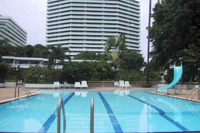 Grand Condotel exterior with ocean view in the background and a canon decoration on the roof.