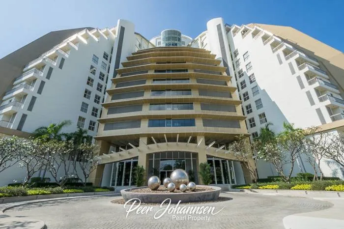 The Cove Pattaya main building exterior with tiered architecture and circular driveway entrance.