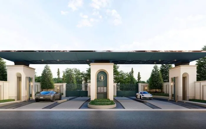 The Palm Grandio's grand entrance gate with a central guardhouse, two luxury cars, and lush green landscaping.