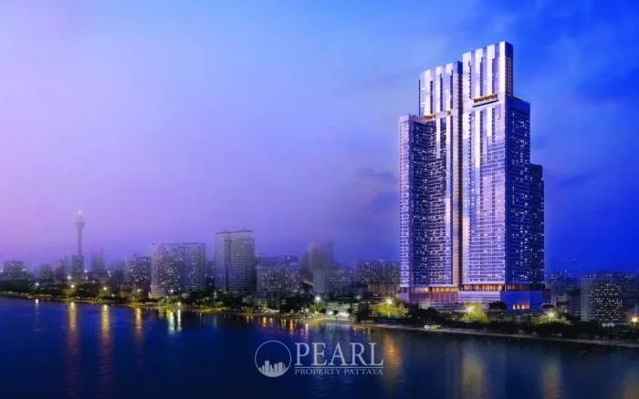 SKYPARK Lucean Jomtien Pattaya main entrance with modern architecture, car driveway, and green landscaping.