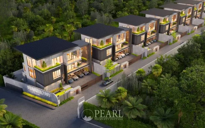 Harmony Hills Villas Pattaya: Aerial view of multiple modern villas nestled in lush green landscape with a road.