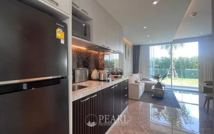 2 Bedroom Condo for Sale in The Coral Pattaya master bedroom with king-size bed and ensuite bathroom