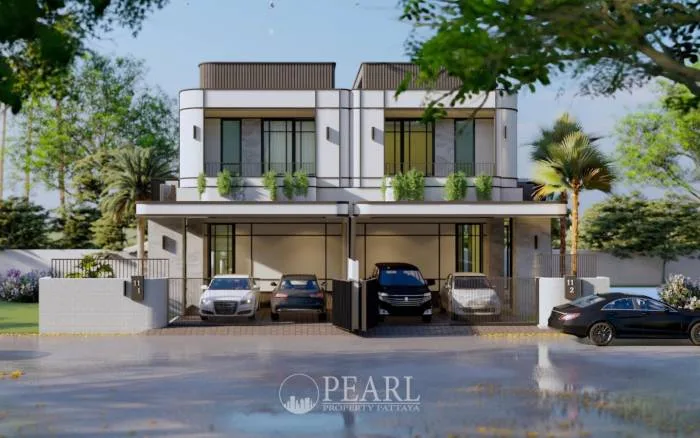 Glam Boonsampan 6 front exterior view of two modern townhouses with integrated carports and lush greenery.