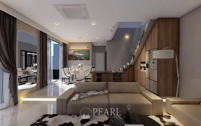 Glam Boonsampan 6 spacious open-plan living room with a large sofa, dining area, and modern kitchen.