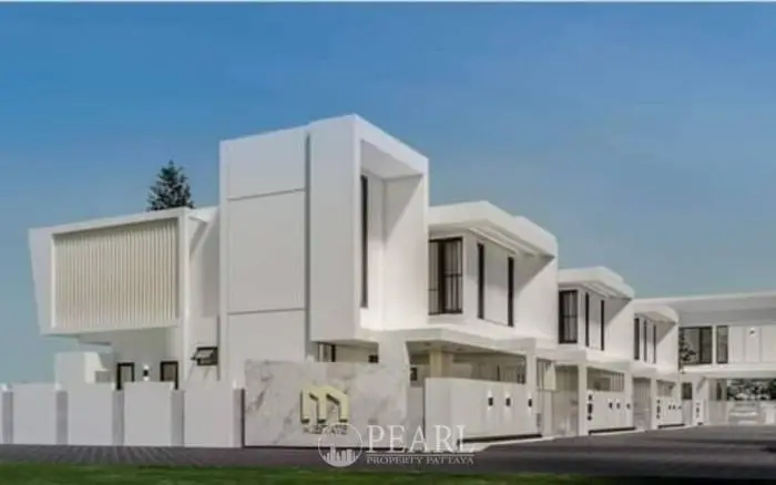 M Estate modern white condo building exterior with a distinctive M logo on a marble wall.