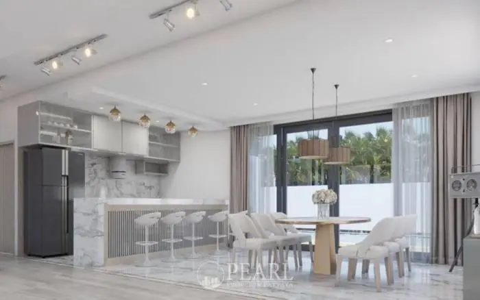 M Estate living room and kitchen with a breakfast bar, white sofas, and dining table.