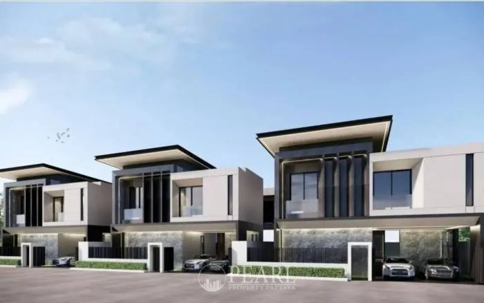 The Cave Ville: Three modern, two-story houses with flat roofs, large windows, and integrated carports under a clear sky.