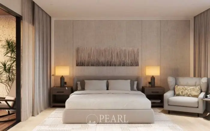 Prime Habitat spacious living room with a large L-shaped sofa, coffee table, and open kitchen in the background.