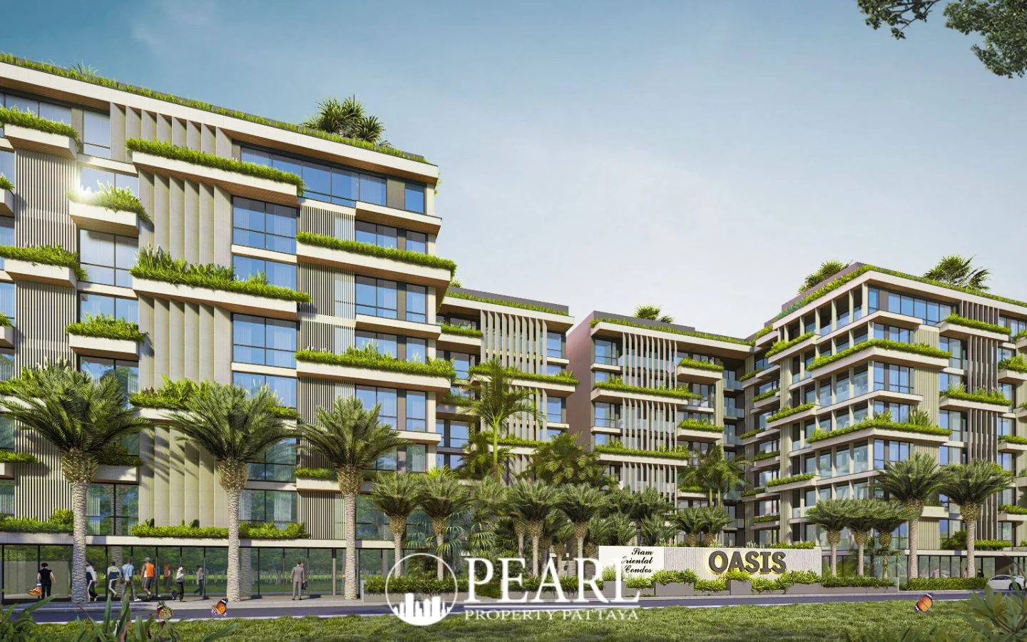 Siam Oriental Oasis modern condo buildings with extensive green landscaping, palm trees, and the property sign at the entrance.
