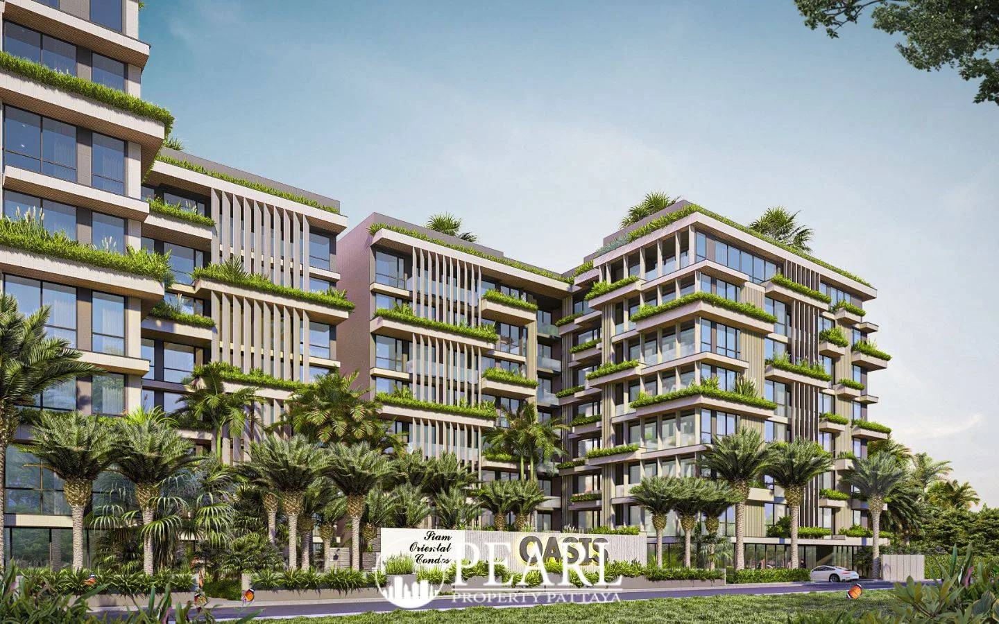 Siam Oriental Oasis modern condo buildings with green landscaping on balconies and rooftops, seen from a street view.
