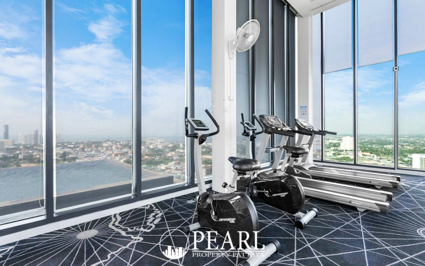 Pattaya Posh rooftop infinity pool with sun loungers and panoramic ocean and city views.