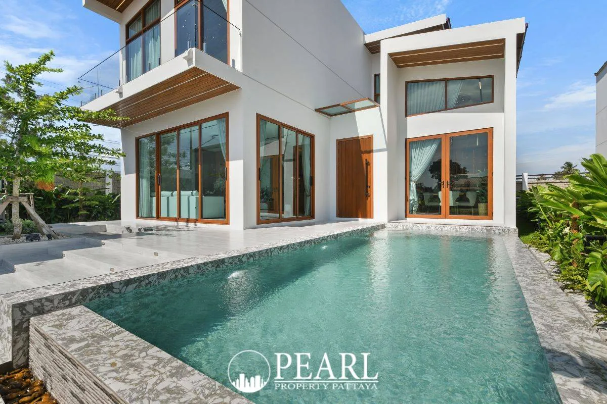 Atmos Prime: Modern white house exterior with private swimming pool and wooden framed glass doors.