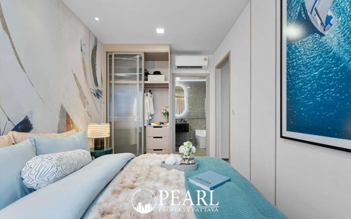 3 Bedroom Condo for Sale at Aquarous Jomtien Pattaya: Bedroom with built-in wardrobe, bed, and ensuite bathroom entrance.