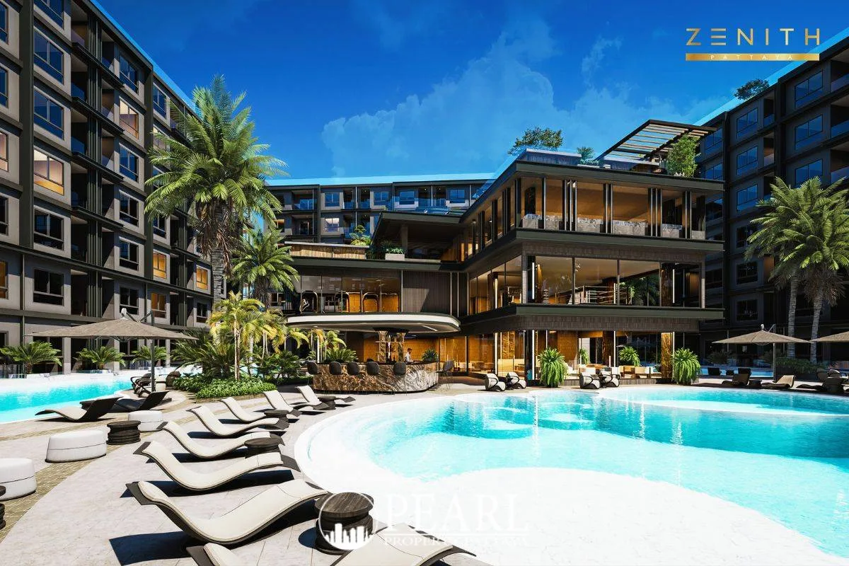 Zenith Pattaya large outdoor swimming pool with sun loungers, surrounded by modern buildings and palm trees.