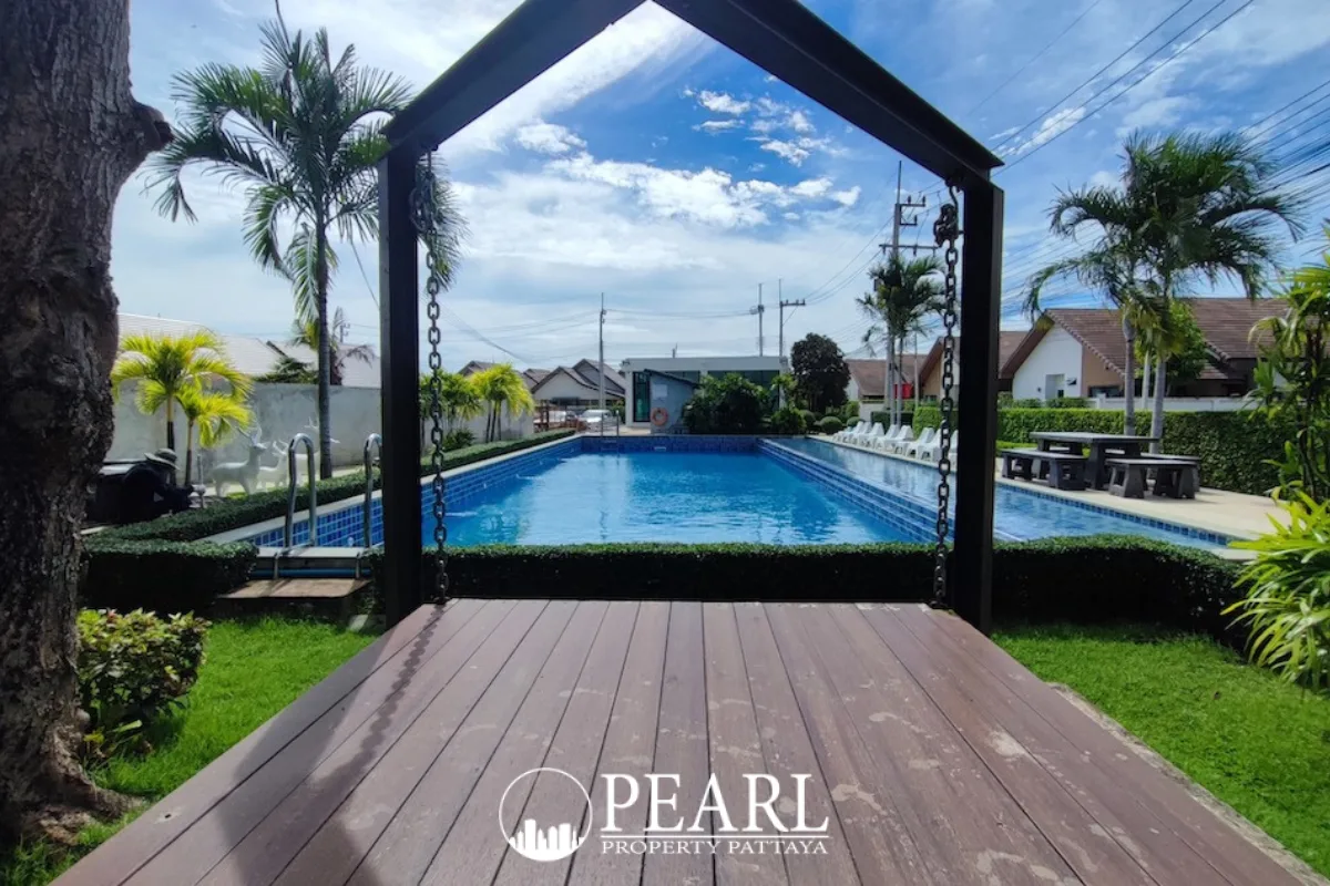 The Maple Pattaya entrance sign with a large red maple leaf logo and manicured shrubs.