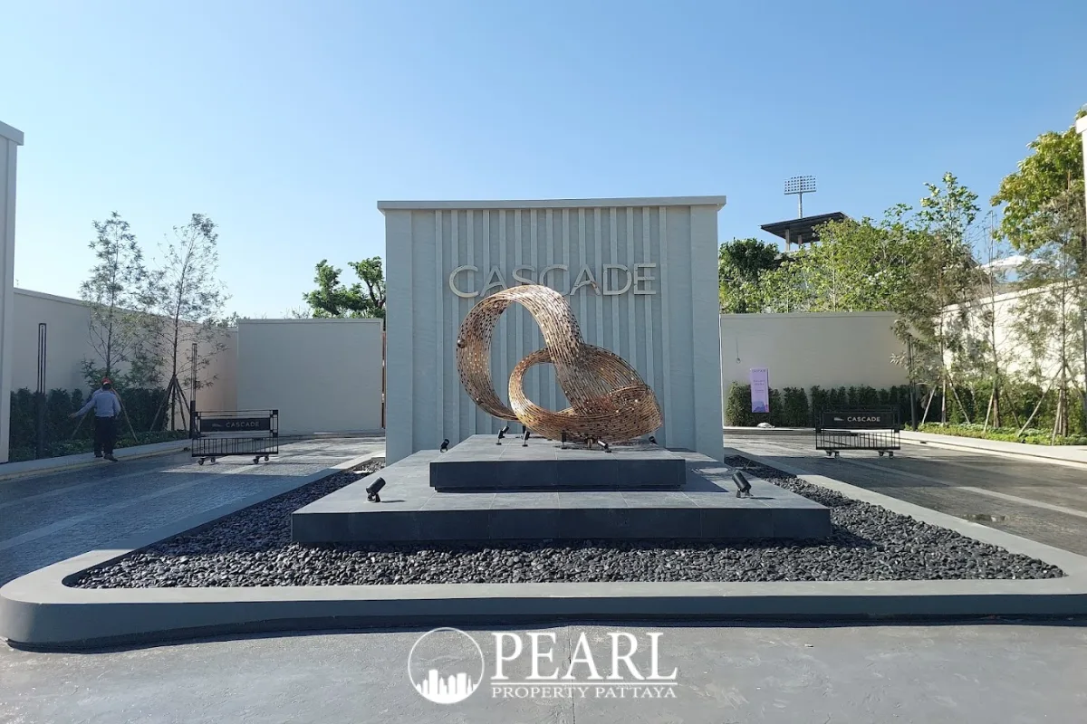 Cascade contemporary house exterior with three cars parked in the driveway and lush green landscaping.