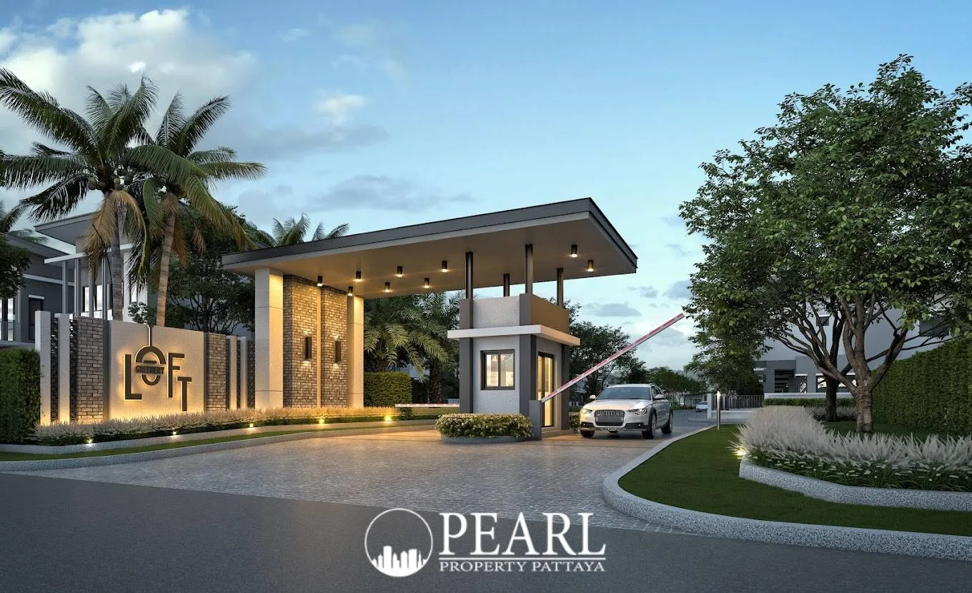 Baan Fah Greenery Loft entrance gate with modern canopy, security booth, a car, and illuminated 'LOFT' signage.