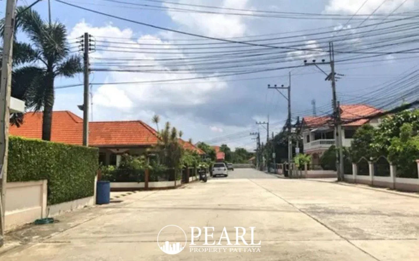 Country Club Villa street view with houses, red tiled roofs, palm trees, and overhead power lines.