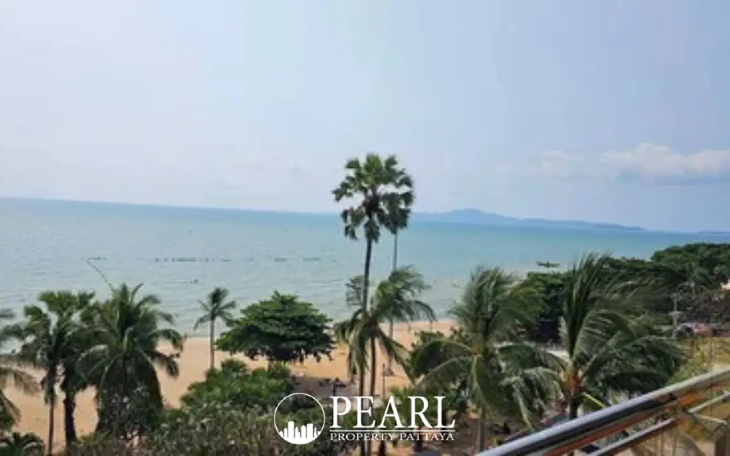 Baan Haad Uthong Condominium panoramic ocean view from a balcony with sandy beach and palm trees.