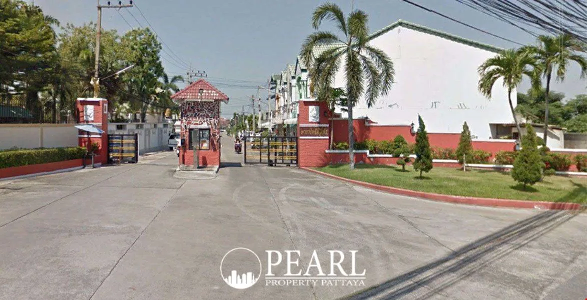 Paradise Hill 2 community entrance with red gatehouse, security gates, and palm trees in Pattaya, Thailand.