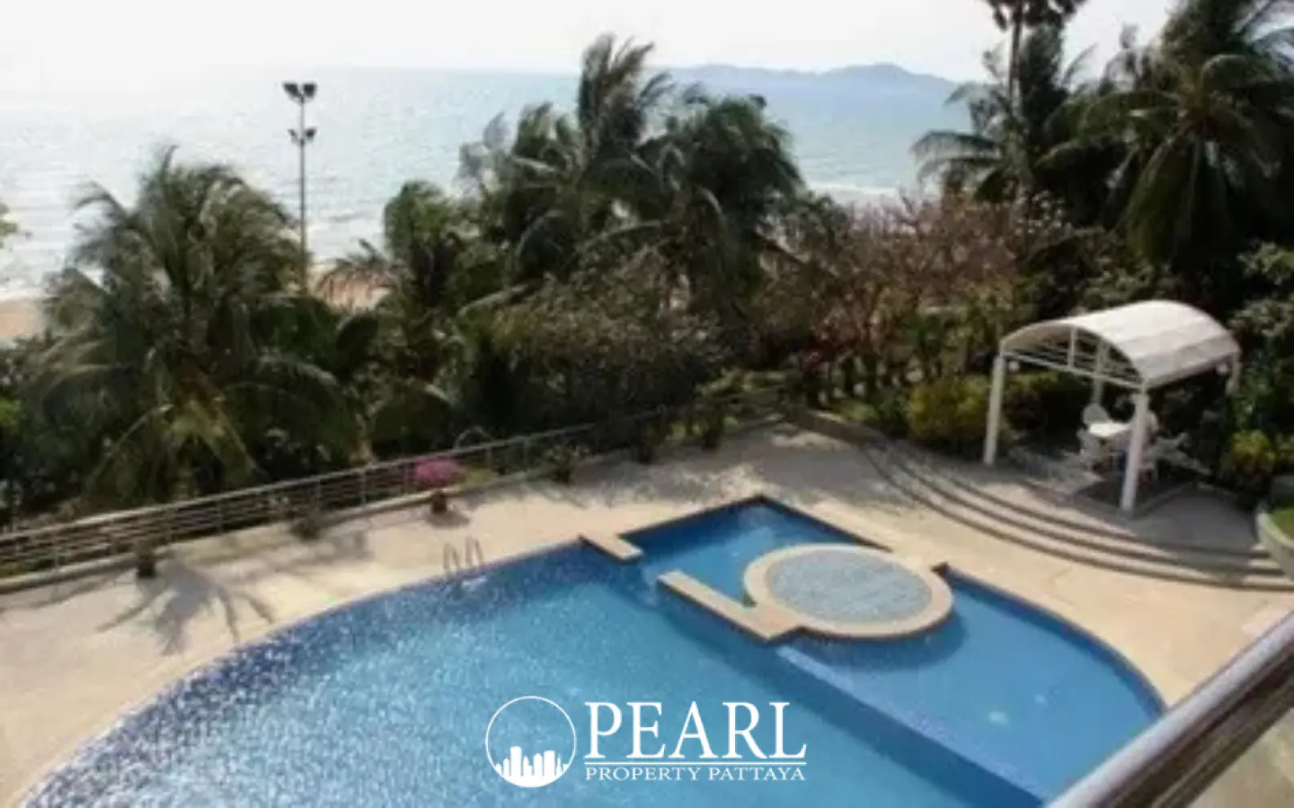 Baan Haad Uthong Condominium outdoor swimming pool with jacuzzi, overlooking a beach and ocean.