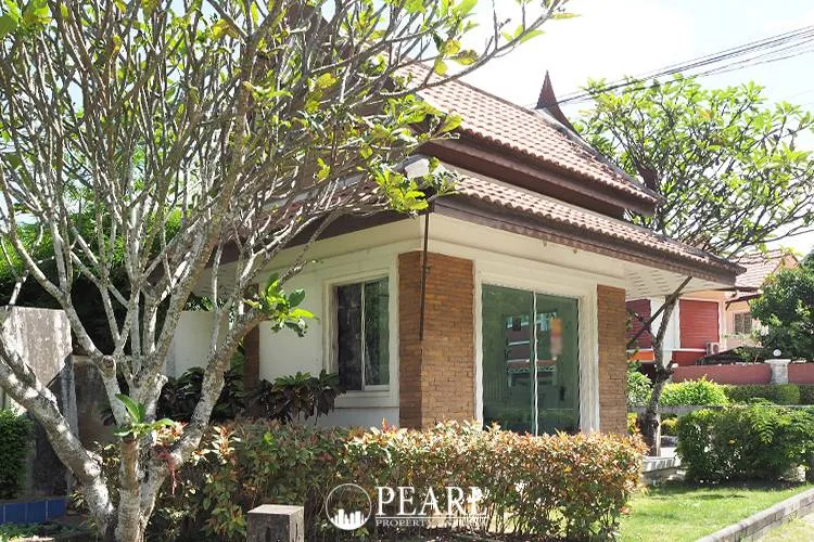 T.W. Wanasin modern white villa with a private swimming pool, green lawn, and multiple balconies.