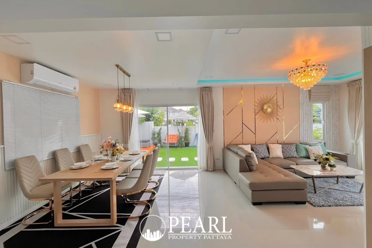 3 Bedroom House for Sale at Baan Pruksa Nara Chaiyapruek: dining area with wooden table, beige chairs, and modern pendant lights.
