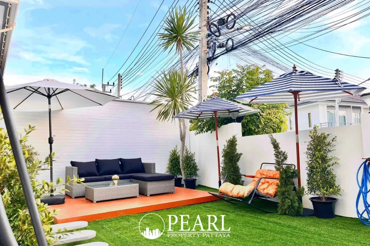 3 Bedroom House for Sale at Baan Pruksa Nara Chaiyapruek: open-plan living and dining area with elegant decor and patio access.