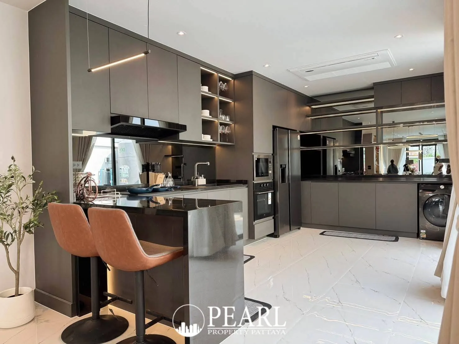 View Point Village modern kitchen with dark cabinets, black island, and stainless steel appliances.