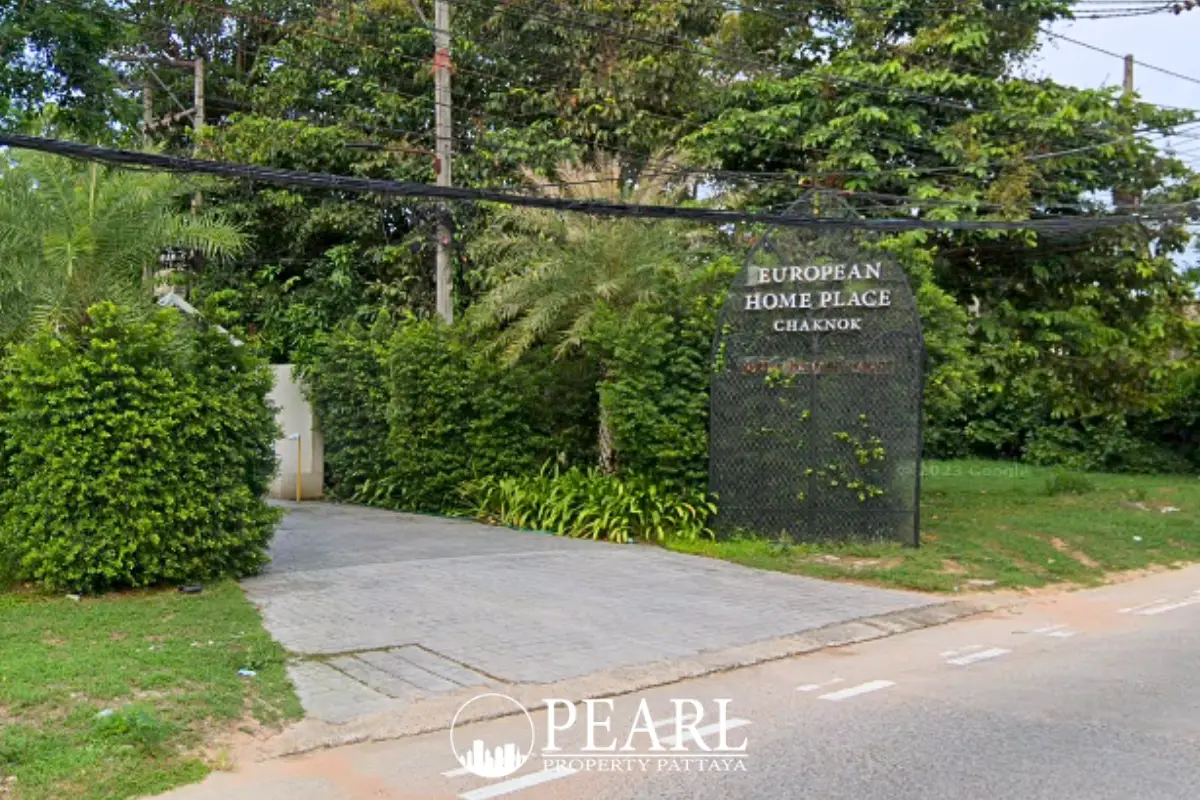European Thai House garden with swimming pool, lush greenery, and palm trees at dusk.