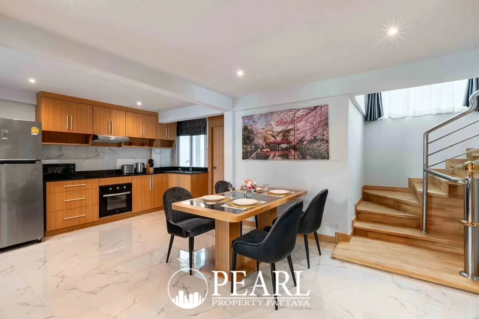 Suksabai Villa living room with a large gray sectional sofa, coffee table, and ceiling fan.