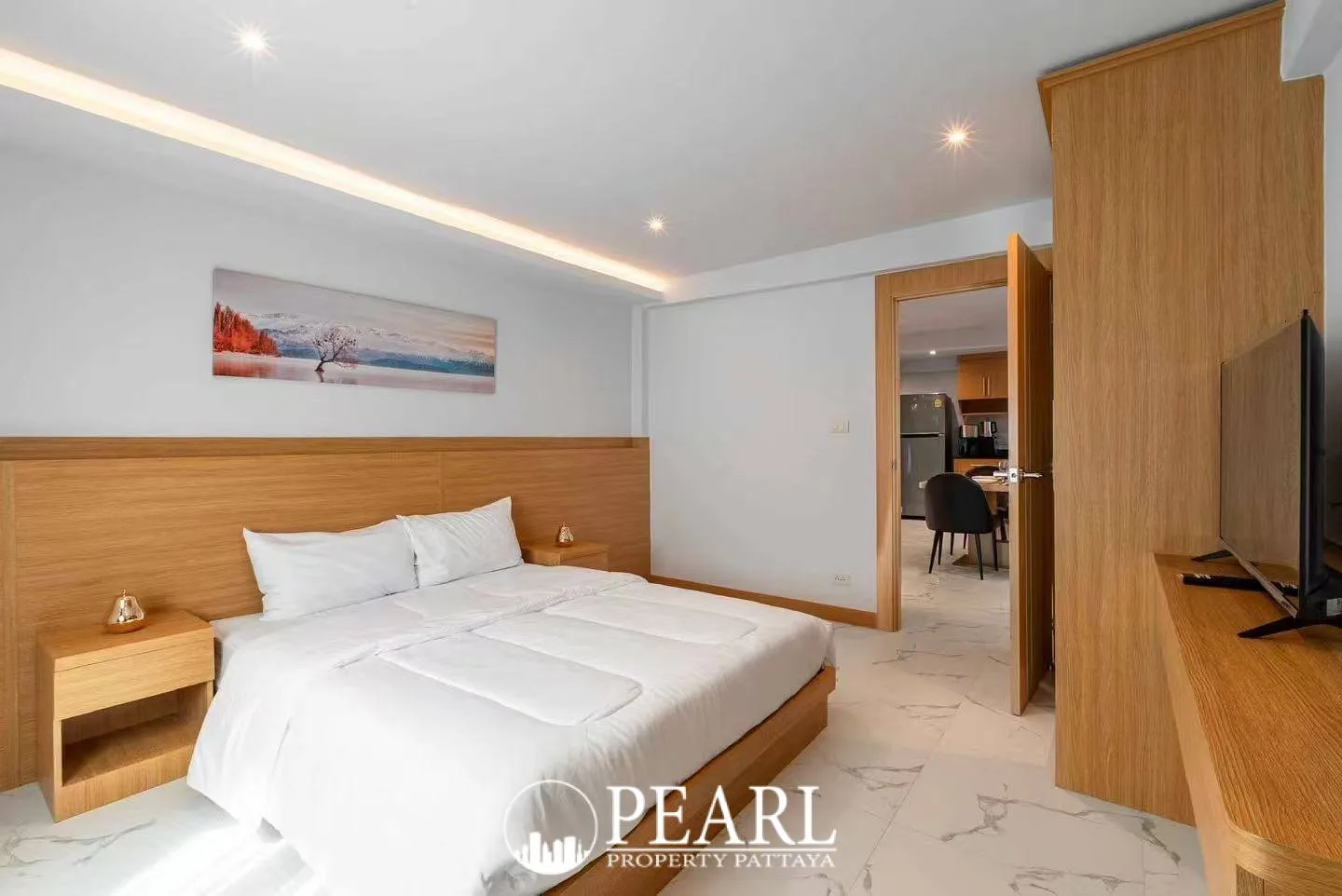 Suksabai Villa narrow outdoor swimming pool with blue tiles, surrounded by lush green plants.