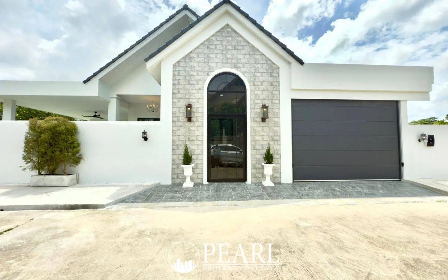 Park Hill Village exterior of a modern house with white walls, arched glass door, and a dark grey garage door.