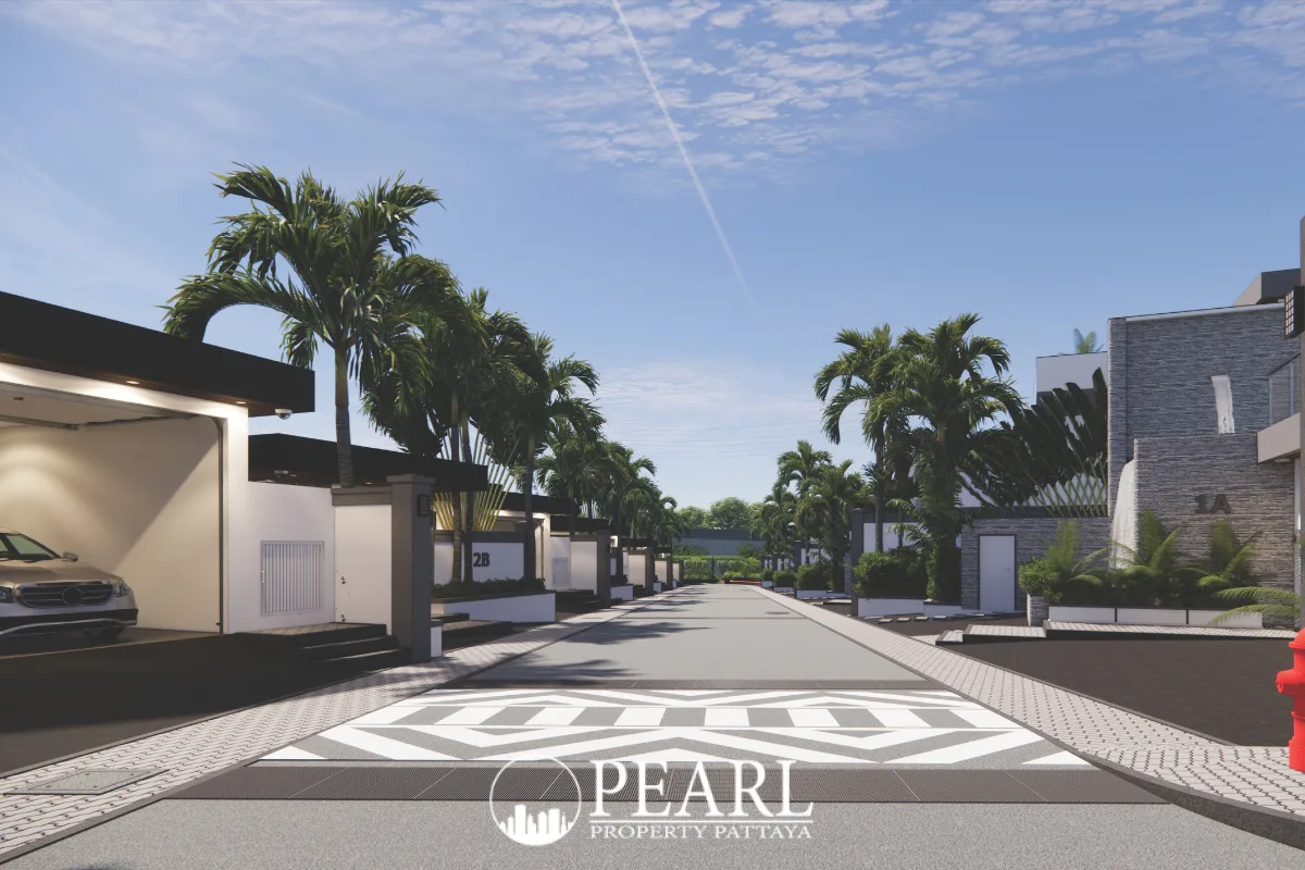 Siam Royal View Lakeside residential street with modern houses, palm trees, and patterned pavement.